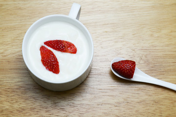strawberry and yogurt on wood table