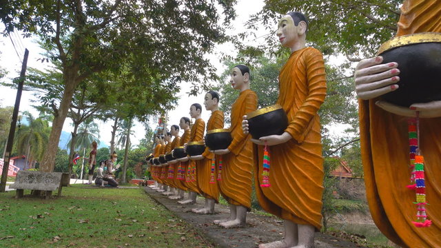 Statue People donate food to the Buddha in Wat sak yai at Chanthaburi Thailand.Public religious places.4k