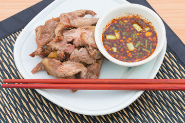 meat grill with sauce on dish.