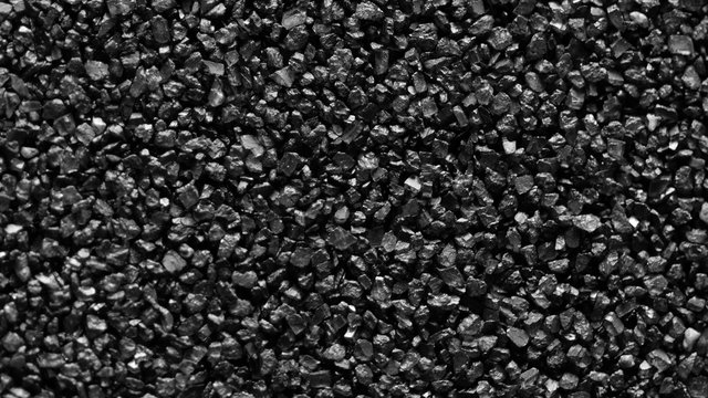 Black sand grunge background. Сlose-up 4K UHD 2160p.
