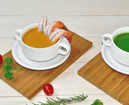 Robster bisques soup with another ingredeints on wood plate