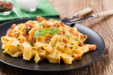 Pasta Carbonara with bacon, basil and cheese