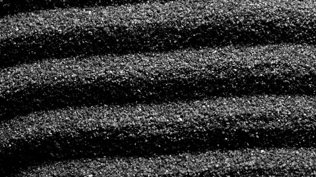 Black sand grunge background. Сlose-up 4K UHD 2160p footage.
