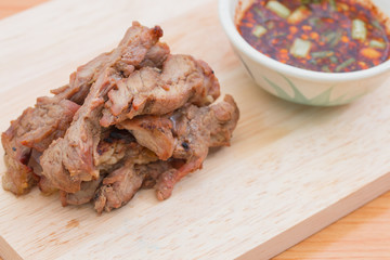 meat grill with sauce on cutting board.