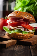 Delicious sandwich with prosciutto ham, cheese and vegetables