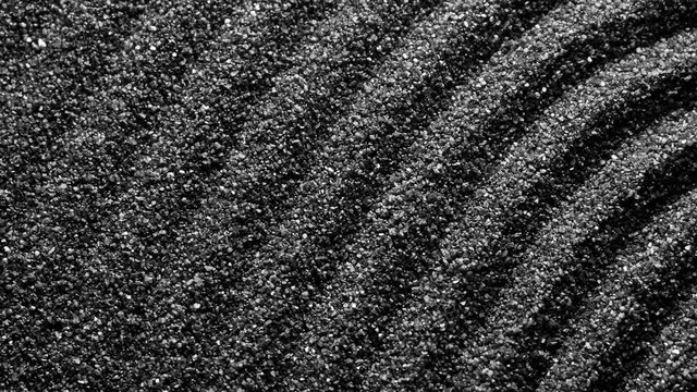 Black sand grunge background. Сlose-up 4K UHD 2160p.
