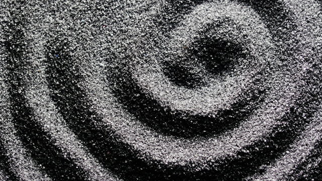 Black sand grunge background. Сlose-up 4K UHD 2160p footage.
