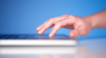Close up of hand pressing keyboard buttons