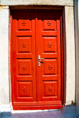 Obraz na płótnie Canvas white red brown door in antique village santorini greece