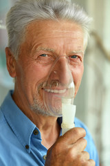 elderly man with flu inhalation