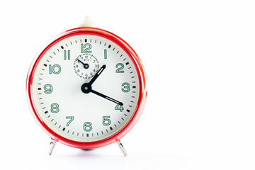 Red alarm clock on the white background.