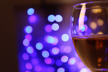 Wine glass with bokeh on dark background