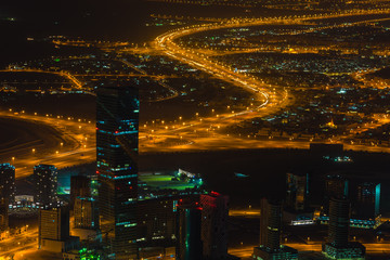 Dubai downtown night scene with city lights. Top view