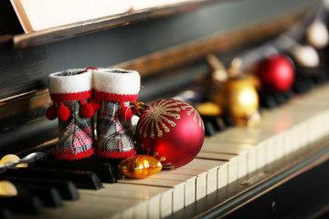 Piano keys decorated with Christmas decorations, close up