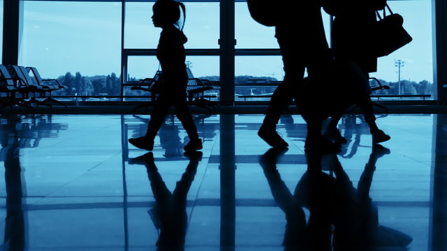 Airport. Unrecognizable Silhouettes of Passengers