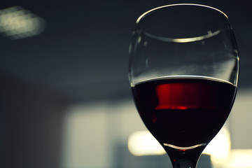 Glass of red wine on blurred background