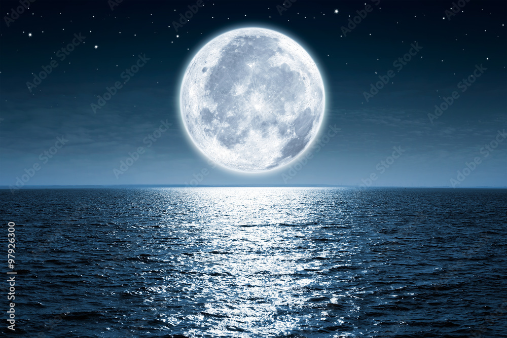Wall mural full moon rising over empty ocean at night with copy space