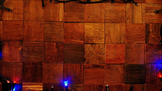 Christmas garland lights on wooden rustic background.
