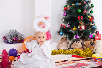 Little girl near the Christmas tree for the New Year