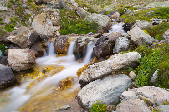 Wild flowing waters in the Alps, long exposure, close up