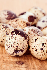 Group of quail eggs on wooden base