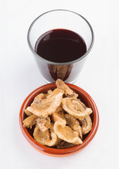 glass of wine and pork rinds