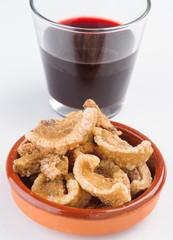 glass of wine and pork rinds