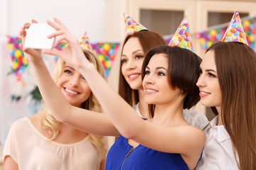 Girls taking group birthday selfie.