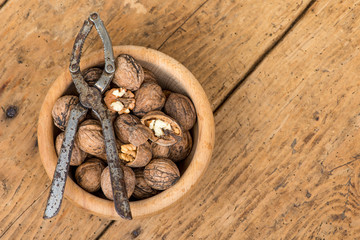 walnuts and nutcracker on an old wooden rustic table