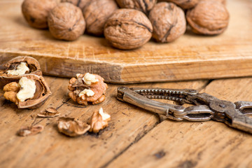walnuts and nutcracker on an old wooden rustic table
