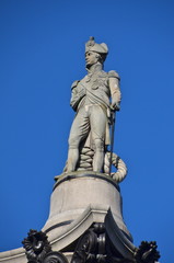 Obraz premium The statue of Admiral Nelson that sits ontop of Nelson's Column in Trafalgar Square in London. 