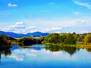 Obraz premium Lake with reflexion, forest and sky