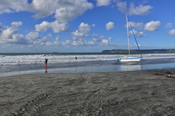 An Abandoned Yacht stranded on a beach in San Diego during rough weather, 
