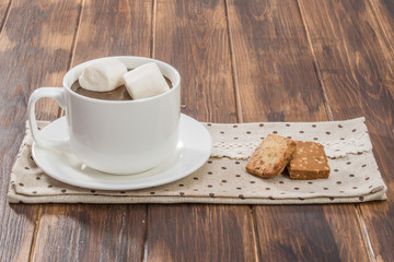 Mug filled with homemade hot chocolate and marshmallow, cookie