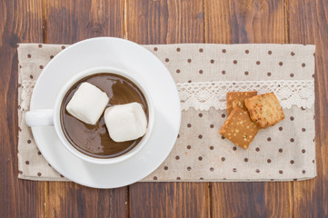 Mug filled with homemade hot chocolate and marshmallow, cookie