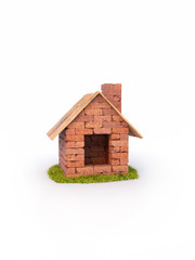 Small house of red bricks, isolated on white