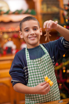 young boy preparing Christmas cookies