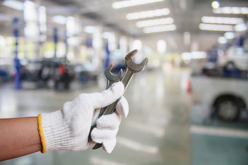 Hand of professional Auto mechanic with wrench