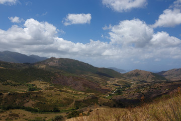 Corsican landscape vista with blue sky and clouds in summer