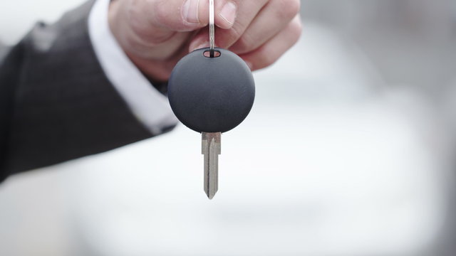 Close up of hand dangling keys to a new car