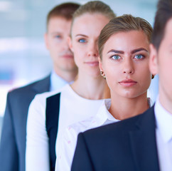 Smiling successful business team standing in office