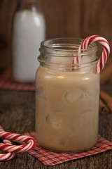Iced coffee in mason jar with candy cane.