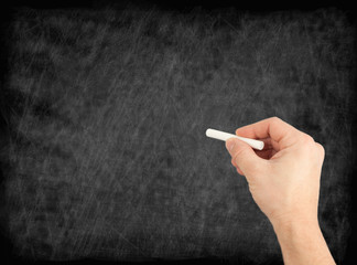 Naklejka premium hand writing by white chalk on a blackboard. Useful as backgroun