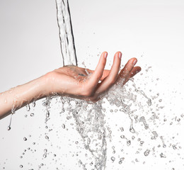 Closeup woman hand under the stream of water