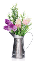 A bouquet of artificial  flowers in galvanize can isolated  on w