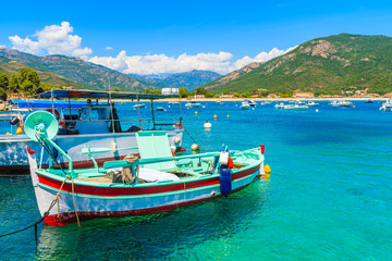 Typical colorful fishing boats in port on coast of southern Corsica island near Cargese town, France