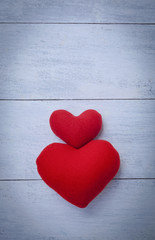 Two red hearts with space on white wood background