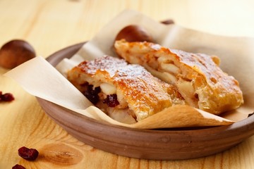 Detail of apple strudel pie in clay bowl