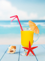 Obraz premium Cocktail with umbrella against the blue