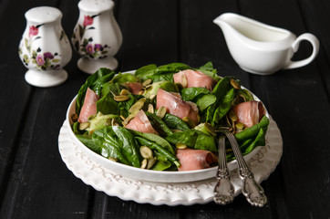 Salad with spinach, avocado and pumpkin seeds salted fish   